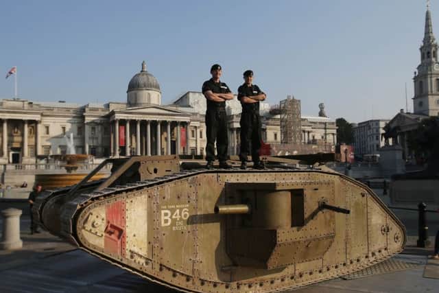 Members of the Royal Tank Regiment stand on a replica First World War Mark IV tank in London's Trafalgar Square. Picture: PA