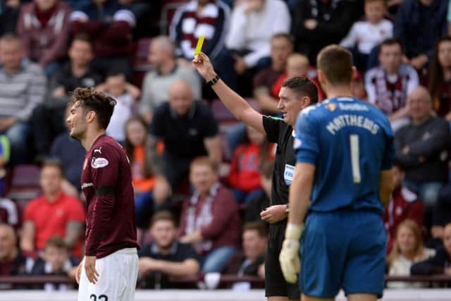 Hearts' Tony Watt is shown a yellow card which was later rescinded. Picture: SNS