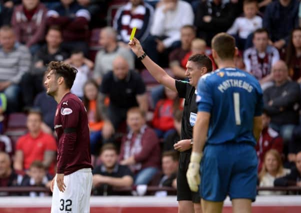 Hearts' Tony Watt is shown a yellow card which was later rescinded. Picture: SNS