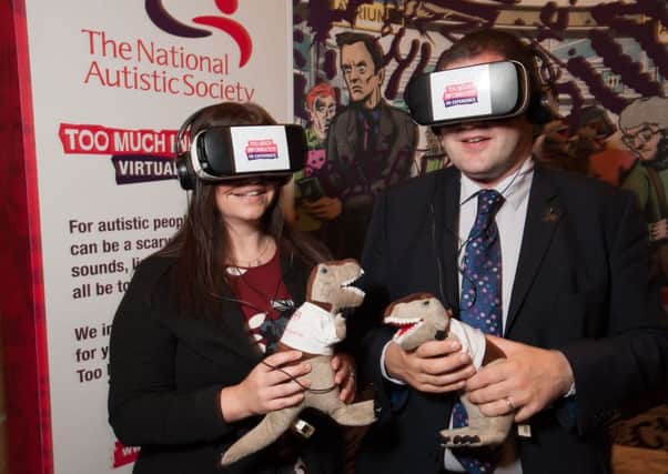 Jenny Paterson (Director, NAS Scotland) with Mark McDonald, Scottish Minister for Child Care and Early Years at Autism Europe 2016, in Edinburgh, exploring the world of a child with autism through virtual reality goggles.
