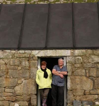 Kenny Macleod & wife Christine (Kenny's a St Kilda descendant) pose for a portrait in front of the home once occupied by his paternal grandmother