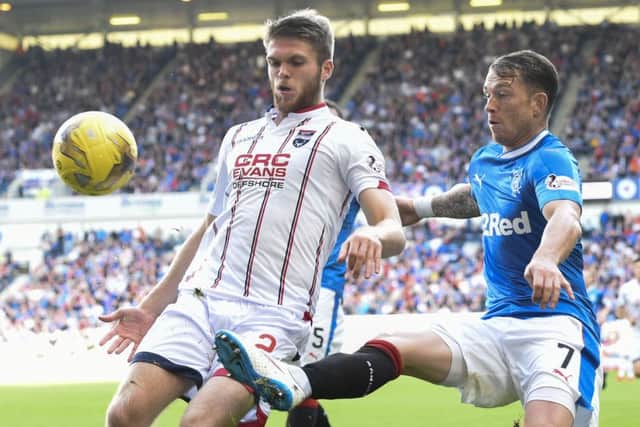 Ross County's Marcus Fraser, left, and Joe Garner tussle for possession during Saturday's stalemate at Ibrox. Picture: SNS