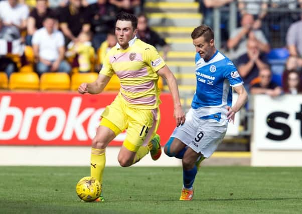 Hearts' John Souttar and St Johnstone's Steven MacLean in action at McDiarmid Park. Picture: SNS