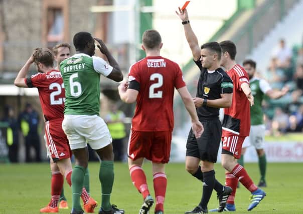 Hibernian's Marvin Bartley (second from the left) is shown a red card in the defeat by Ayr United. Picture: SNS