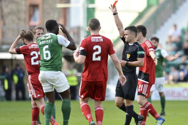 Hibernian's Marvin Bartley (second from the left) is shown a red card in the defeat by Ayr United. Picture: SNS