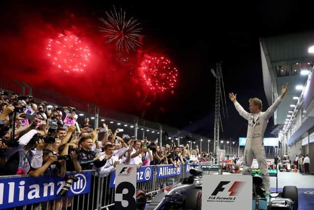 Nico Rosberg celebrates his win in the Singapore Grand Prix at the Marina Bay Street Circuit. Picture: Lars Baron/Getty Images