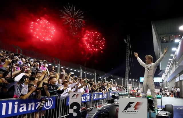 Nico Rosberg celebrates his win in the Singapore Grand Prix at the Marina Bay Street Circuit. Picture: Lars Baron/Getty Images