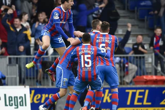 Inverness players celebrate after Alex Fisher (hidden) scores a late equaliser. Picture: SNS.