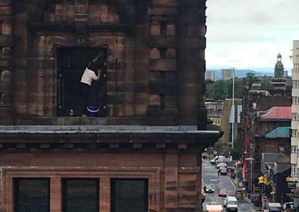 Mo Kam Tai, 76, regularly climbs onto the ledge to clean her windows. Picture: Twitter