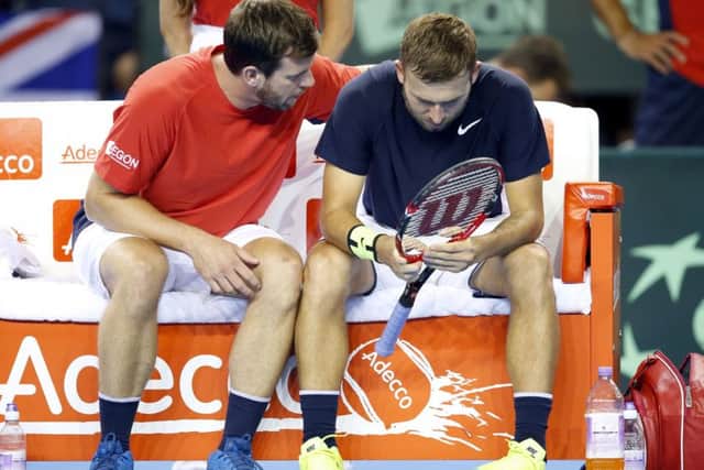 Great Britain coach Leon Smith, left, consoles  Dan Evans whose defeat gave victory to Argentina. Picture: PA.