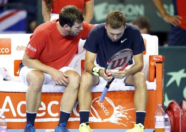 Great Britain coach Leon Smith, left, consoles  Dan Evans whose defeat gave victory to Argentina. Picture: PA.