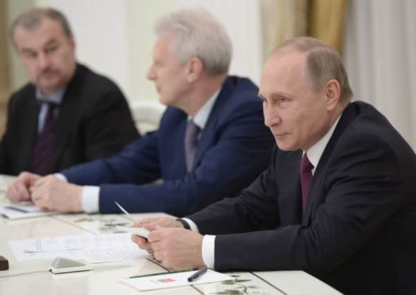 Russian President Vladimir Putin at a meeting yesterday as voting continued for the Duma. Picture: Getty Images