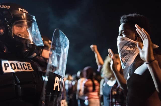 Police officers face off with angry crowds on Interstate 85 during protests following the death of a man shot by a police officer. Picture: Getty Images