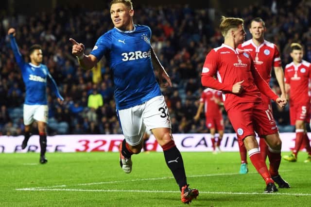 Rangers' Andy Halliday kisses the badge after he scores his side's second goal. Picture: Craig Foy/SNS