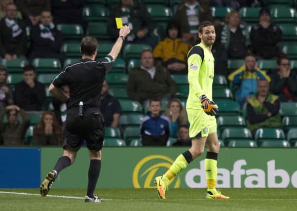 Celtic goalkeeper Craig Gordon is shown the yellow card for a challenge on Alloa's Greig Spence.