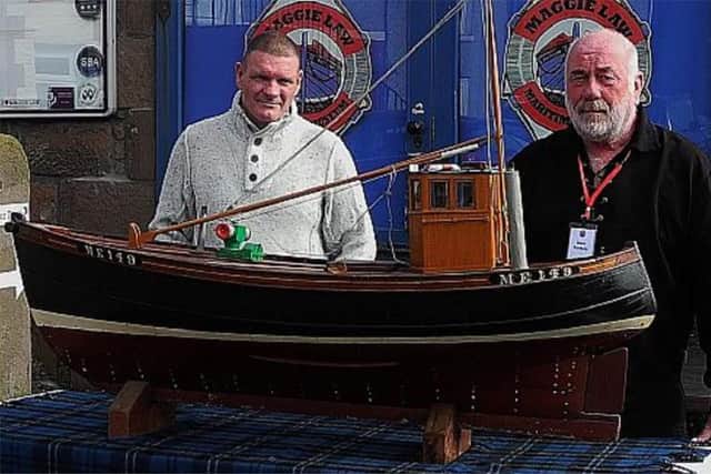 Alan Ritchie (left), the great nephew of Bella skipper James Ritchie, with a model of the Happy Return, the boat which his great uncle bought after being released from the German PoW. PIC contributed.