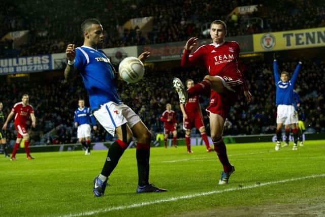 Kyle Bartley and Clark Robertson battle for possession during the 2012 encounter. Picture: SNS