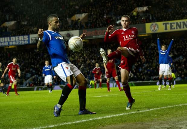 Kyle Bartley and Clark Robertson battle for possession during the 2012 encounter. Picture: SNS