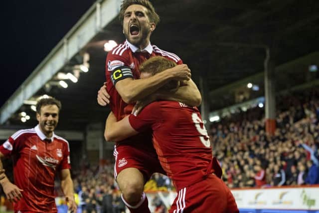 Adam Rooney celebrates with Graeme Shinnie after grabbing the late winner at Pittodrie