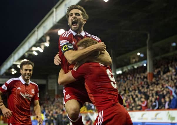 Adam Rooney celebrates with Graeme Shinnie after grabbing the late winner at Pittodrie