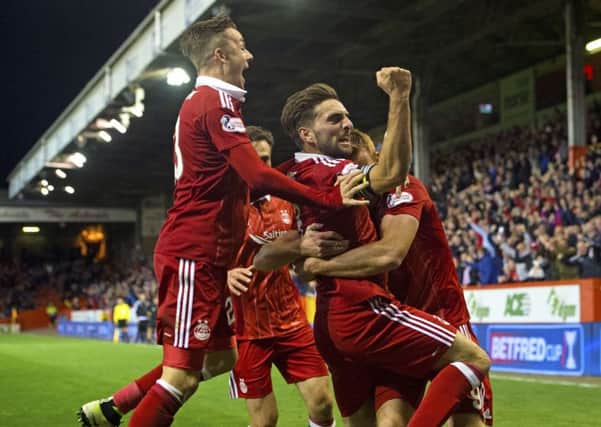 Aberdeen players celebrate Adam Rooney's late winner in the League Cup quarter-final against St Johnstone. Picture: Craig Foy/SNS