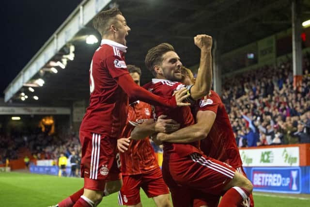 Aberdeen players celebrate Adam Rooney's late winner in the League Cup quarter-final against St Johnstone. Picture: Craig Foy/SNS