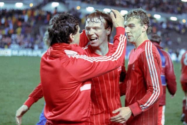 Neale Cooper, right, celebrates Aberdeen's European Cup Winners' Cup final win over Real Madrid in 1983 with Alex McLeish, centre, and Eric Black. Picture: SNS Group