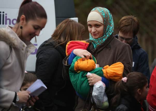 Syrian refugee families, welcomed by the Scottish Government, arrive at their new homes on the Isle of Bute. Picture: Getty Images
