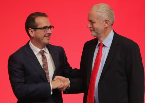 Jeremy Corbyn MP shakes hands with Owen Smith MP . Picture: Getty