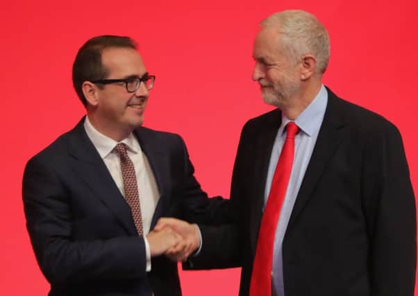 Jeremy Corbyn MP  shakes hands with Owen Smith MP . Picture: Getty