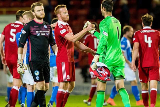 Aberdeen's Adam Rooney and Joe Lewis congratulate each other at full-time following the 1-0 quarter-final win against St Johnstone. Picture: SNS