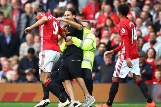 A Zlatan Ibrahimovic lookalike invades the pitch and attempts to reach the Manchester United striker during the match with Leicester City at Old Trafford. Picture: Clive Brunskill/Getty Images