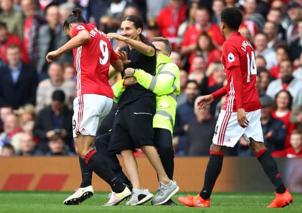 A Zlatan Ibrahimovic lookalike invades the pitch and attempts to reach the Manchester United striker during the match with Leicester City at Old Trafford.  Picture: Clive Brunskill/Getty Images