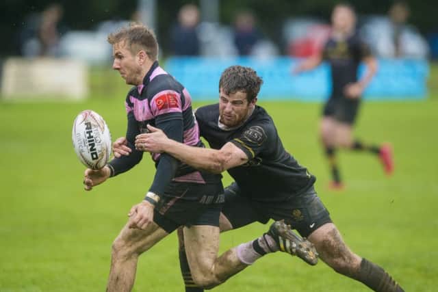 Melrose's Grant Runciman, right, battles for the ball against Ayr's David Armstrong