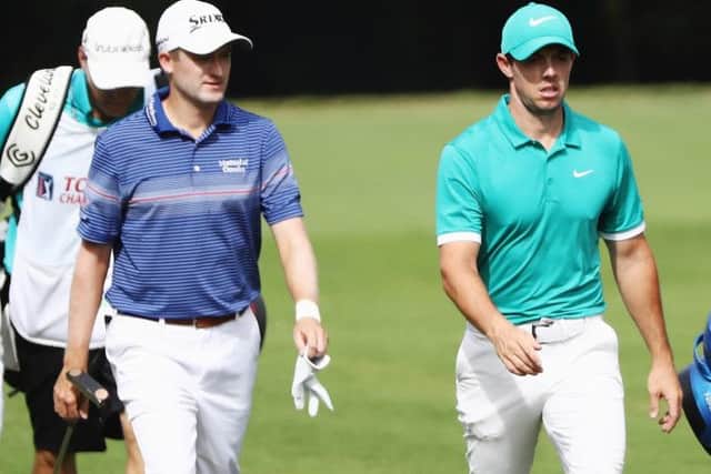 Russell Knox walks with playing partner Rory McIlroy in the third round of the Tour Championship in Atlanta. Picture: Getty Images