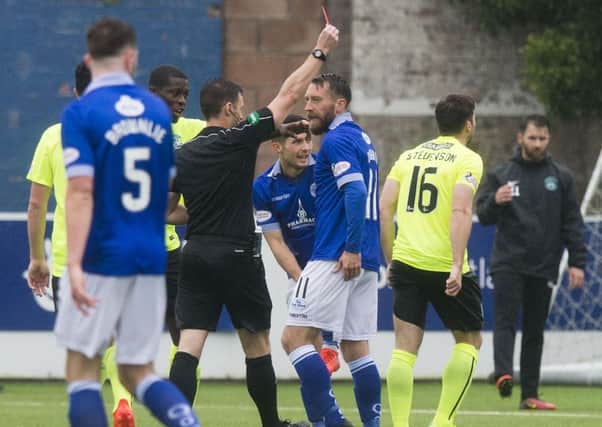 Hibernian's Lewis Stevenson, right, is sent off at Palmerston Park. Picture: SNS.