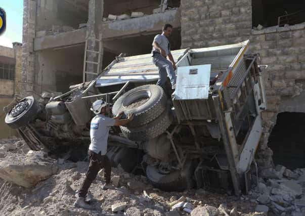 Rescue workers remove a destroyed ambulance outside the Syrian Civil Defence main centre after airstrikes in eastern Aleppo.
Picture:  AP