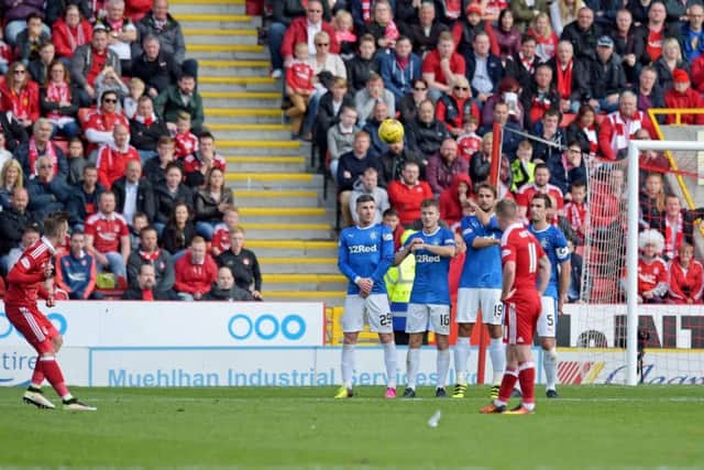 James Maddison curls in a late free-kick to win the game for Aberdeen. Picture: SNS.