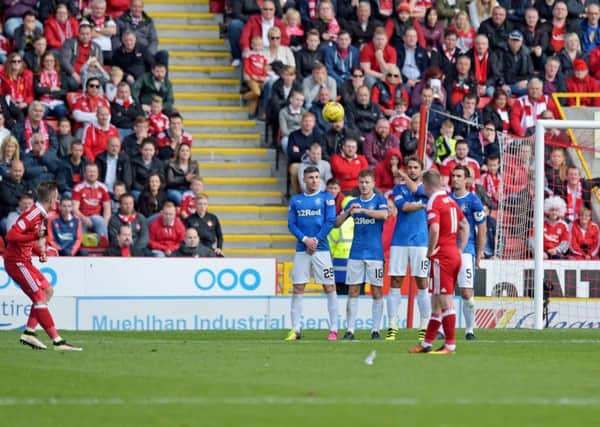 James Maddison curls in a late free-kick to win the game for Aberdeen. Picture: SNS.