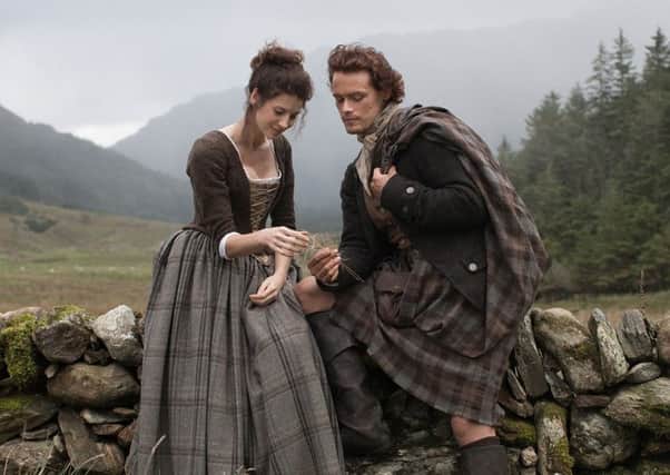 Caitriona Balfe and Sam Heughan playing Claire Randall and Jamie Fraser in the TV series Outlander.