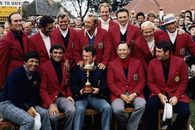 Jack Burke, Jr., captain of the United States, holding the Ryder Cup trophy, celebrates with his team members. Picture: Getty.