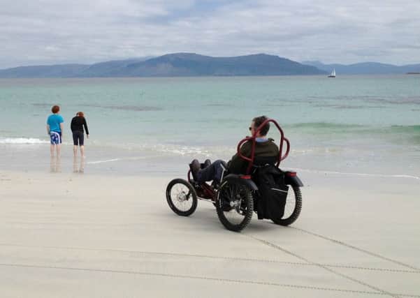 Calum Ferguson at the beach on his rehab cycling machine. Picture: Contributed