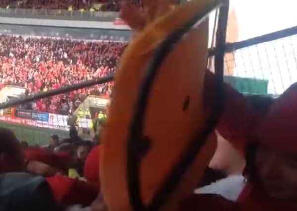 The clips shows a fan being hit by a chair