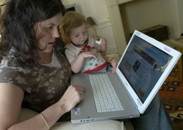 Helen Fowler updates her blog with daughter. Picture: Julie Bull