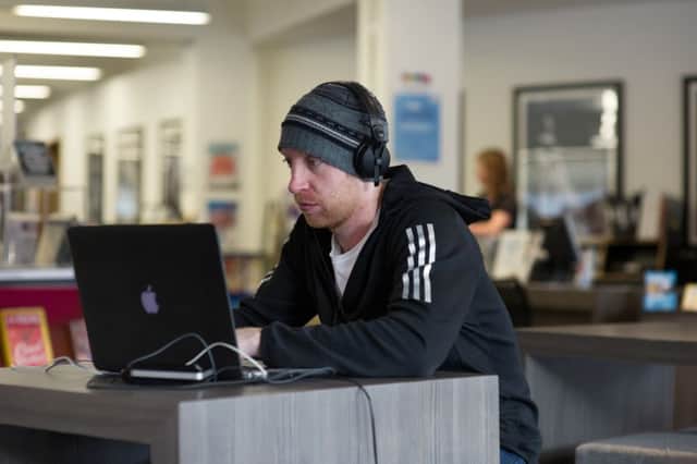 Customers at Bridgeton Library are encouraged to use their own laptops when browsing the internet - but a sizable number of Scots remain cut off from online activites. Picture: John Devlin/TSPL