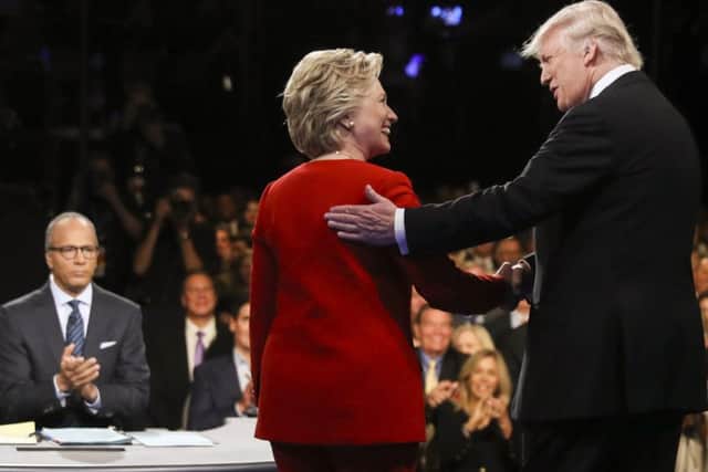 Democratic presidential nominee Hillary Clinton and Republican presidential nominee Donald Trump shake hands during the presidential debate. Picture AP