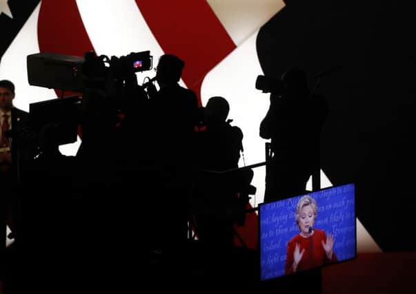Democratic presidential nominee Hillary Clinton appears on a monitor during the presidential debate with Republican presidential nominee Donald Trump. Picture: AP