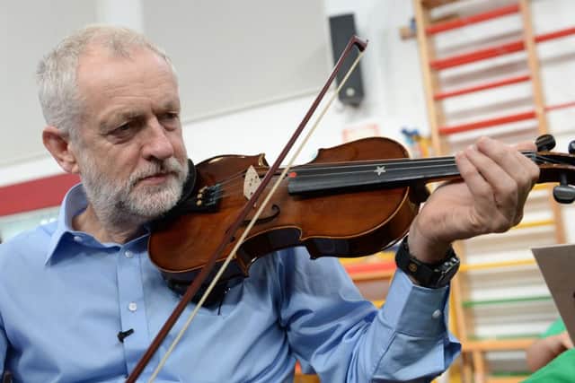 Labour leader Jeremy Corbyn plays the violin during a visit to Faith Primary School in Liverpool. Picture; Stefan Rousseau
