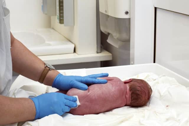 Stock image. Doctor examines a newborn baby