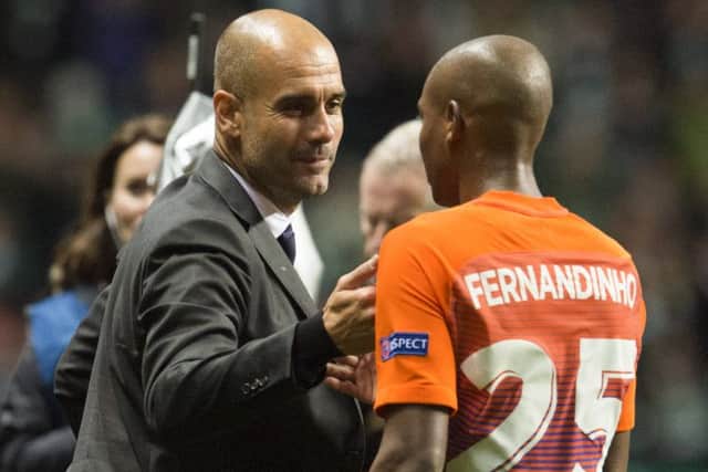 Manchester City manager Pep Guardiola (left) with Fernandinho at full-time. Picture: SNS